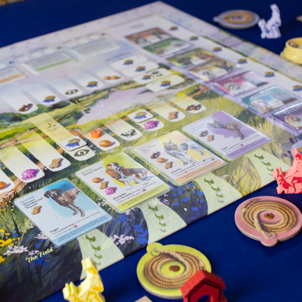 The board game set up with cards and tokens.